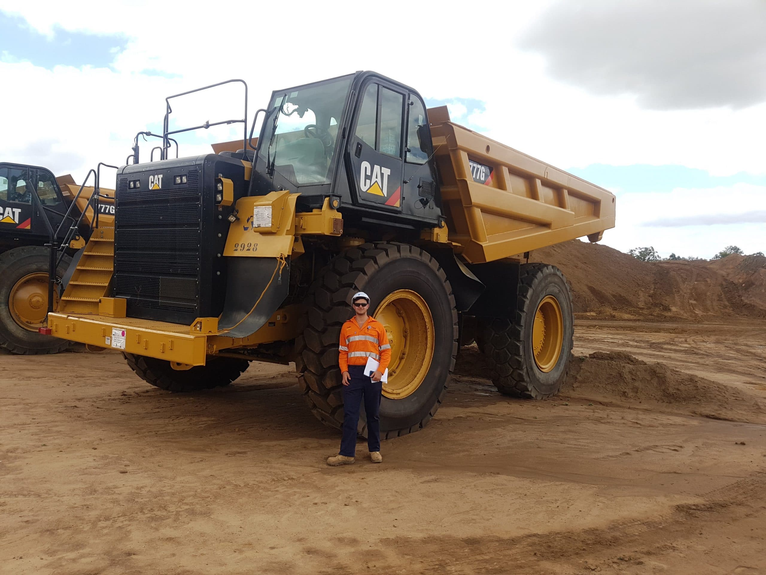 Jose Nazareno standing in front of a large truck