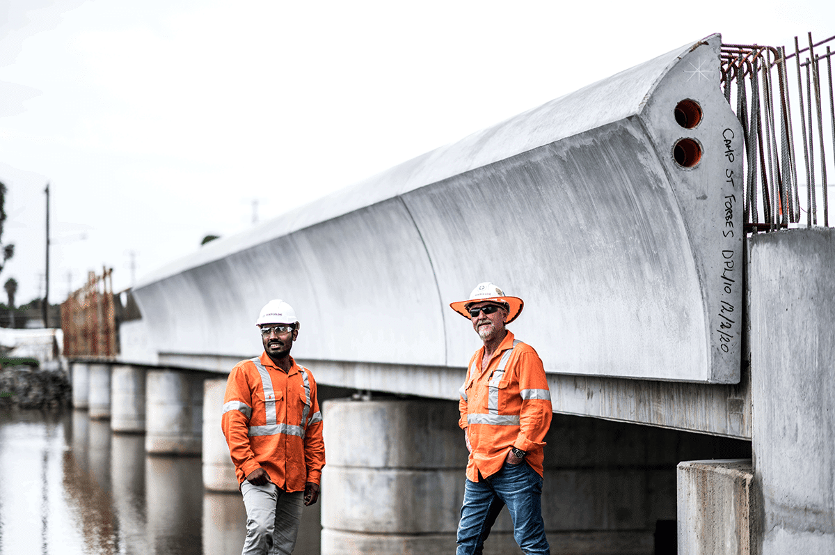 Two workers by Camp Street Bridge during Parapet Installation