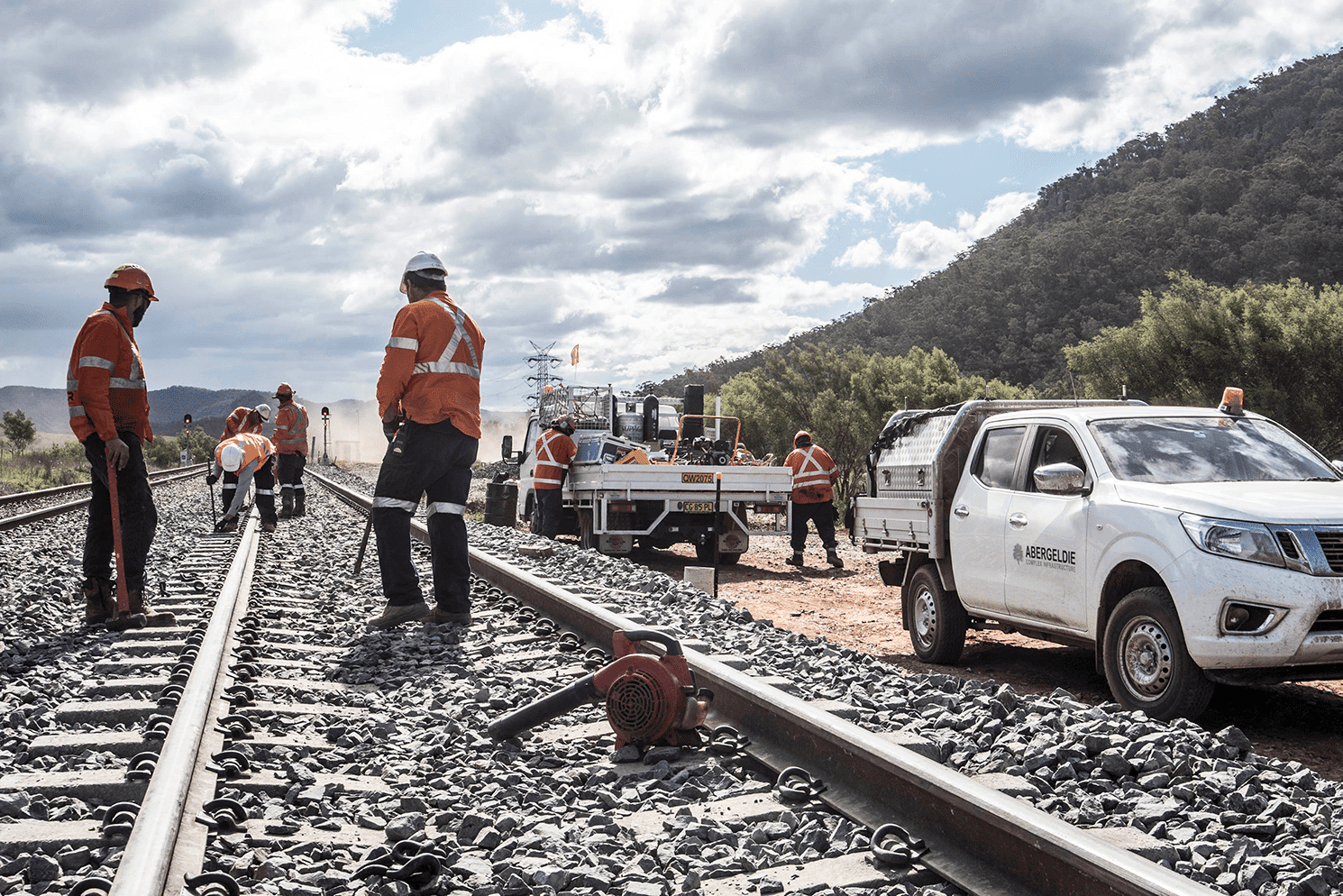 Workers standing on track looking onwards and an Abergeldie Car