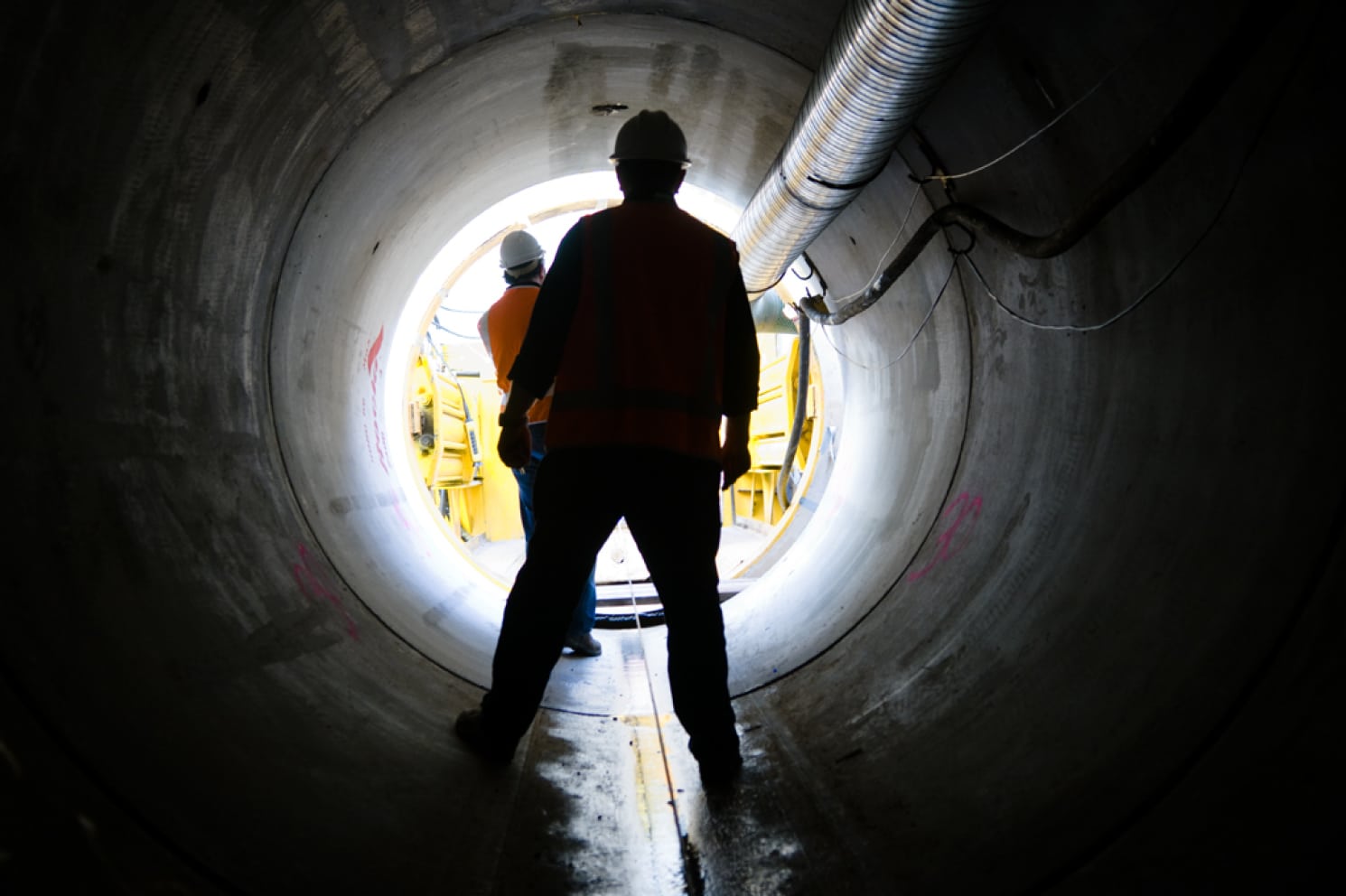 Man looking out of a tunnel in New Zealand