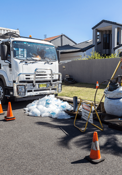 Photo of a relining truck next to a residential area where they are rehabilitating the stormwater