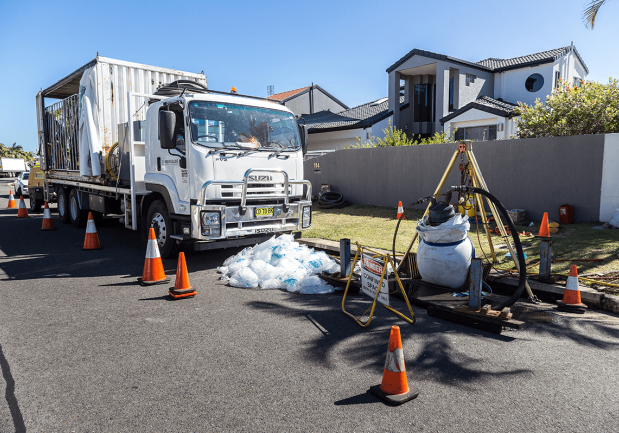 Photo of a relining truck next to a residential area where they are rehabilitating the stormwater